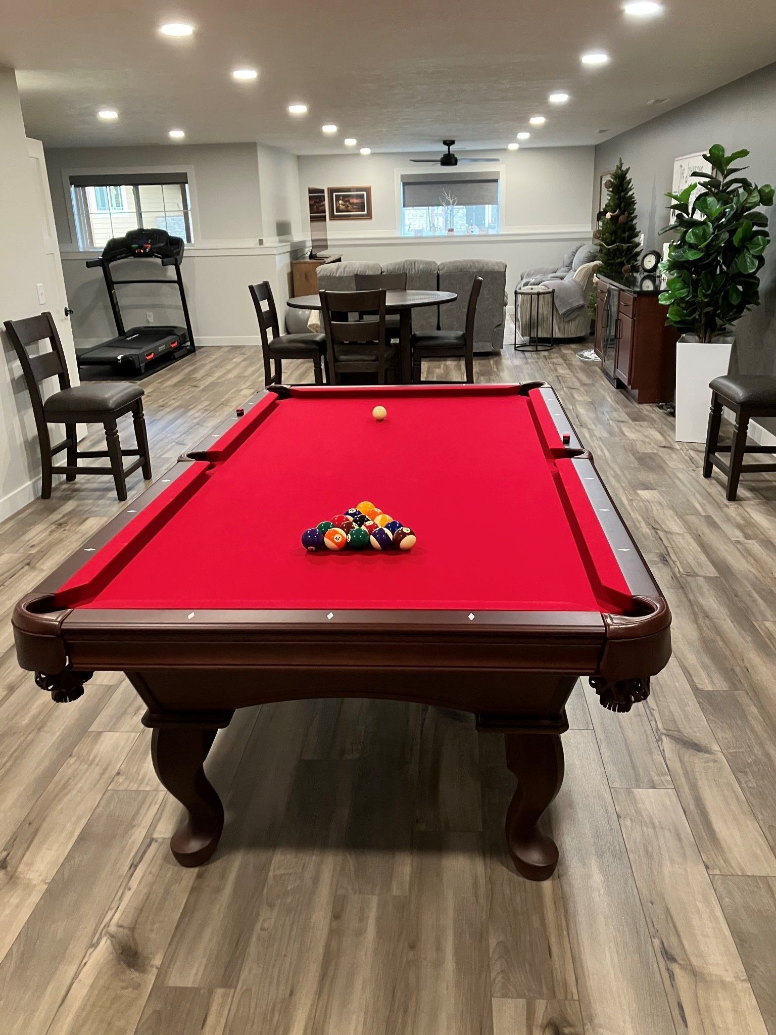 There is a pool table in the middle of the room.