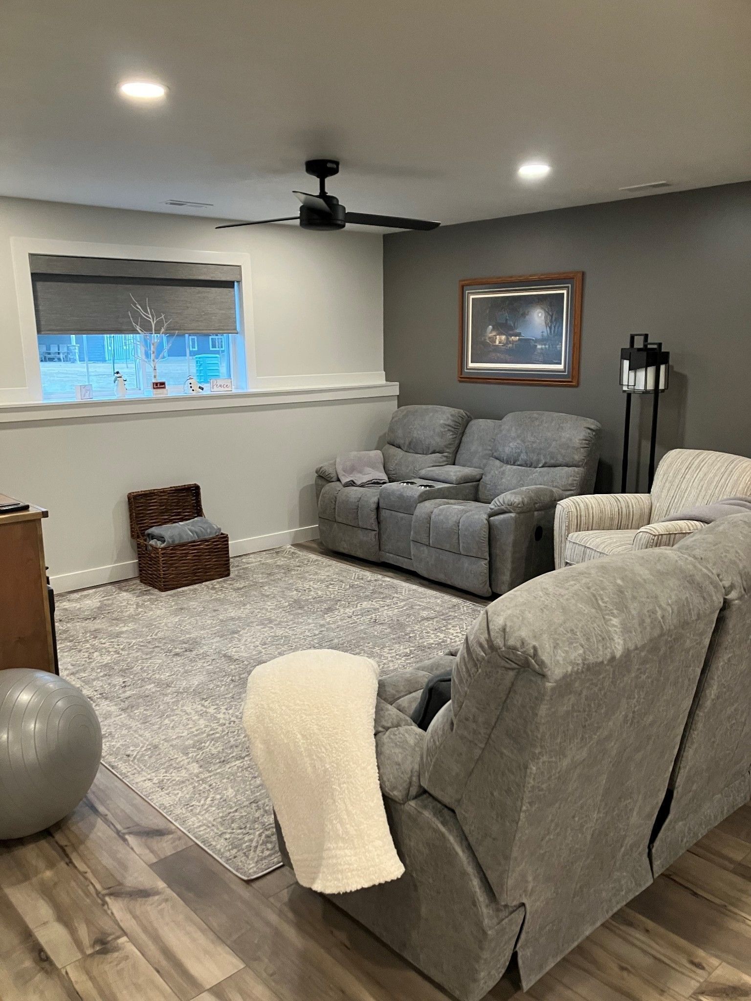A living room filled with furniture and a ceiling fan.