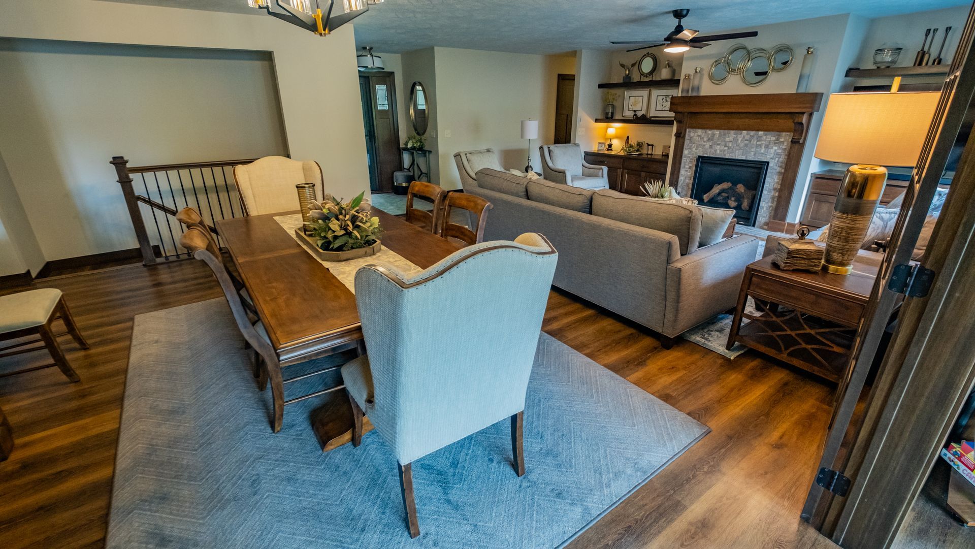 A living room with a dining table and chairs and a fireplace.
