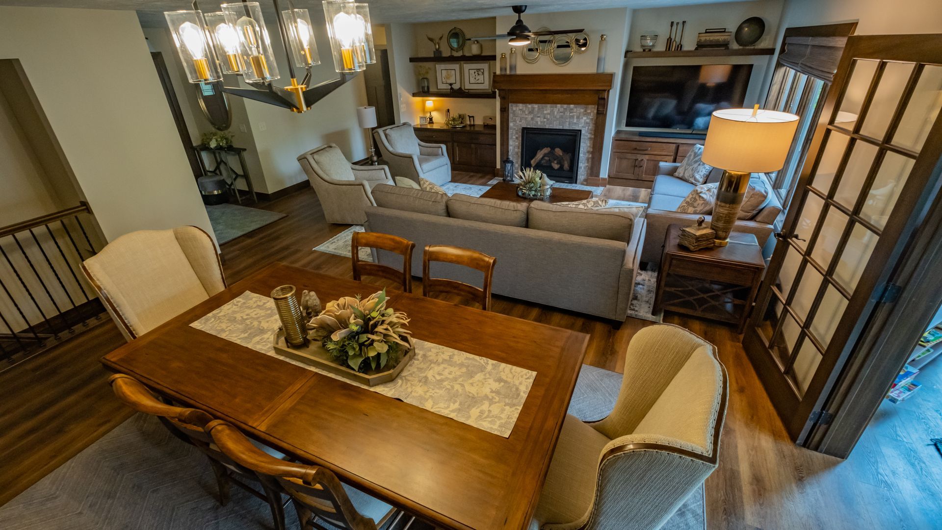 A living room with a dining table and chairs and a fireplace.