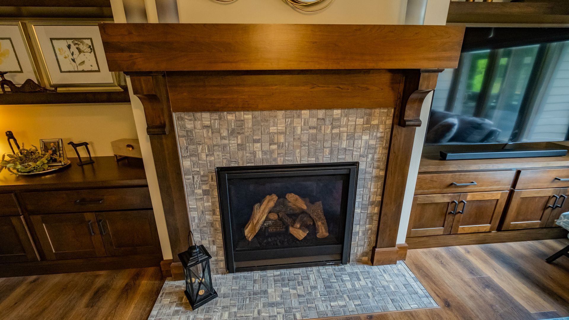 A living room with a fireplace and a television.