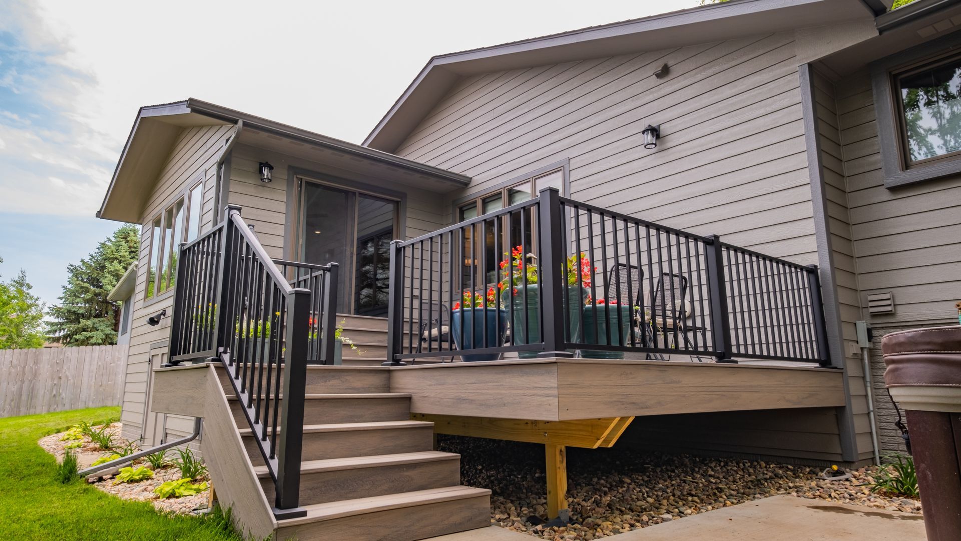 A house with a deck and stairs leading up to it.