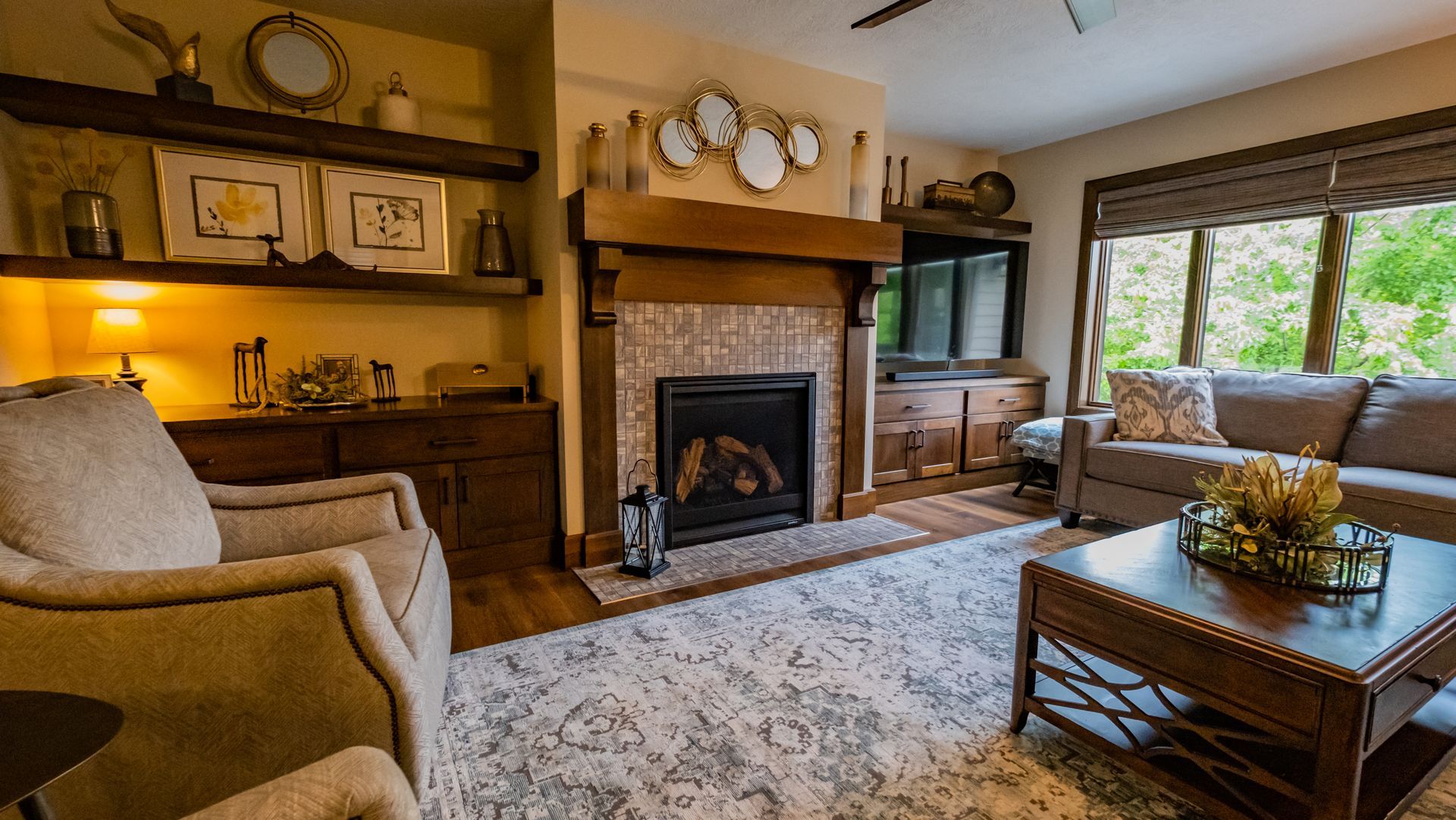 A living room with a fireplace, couch, chair and coffee table.
