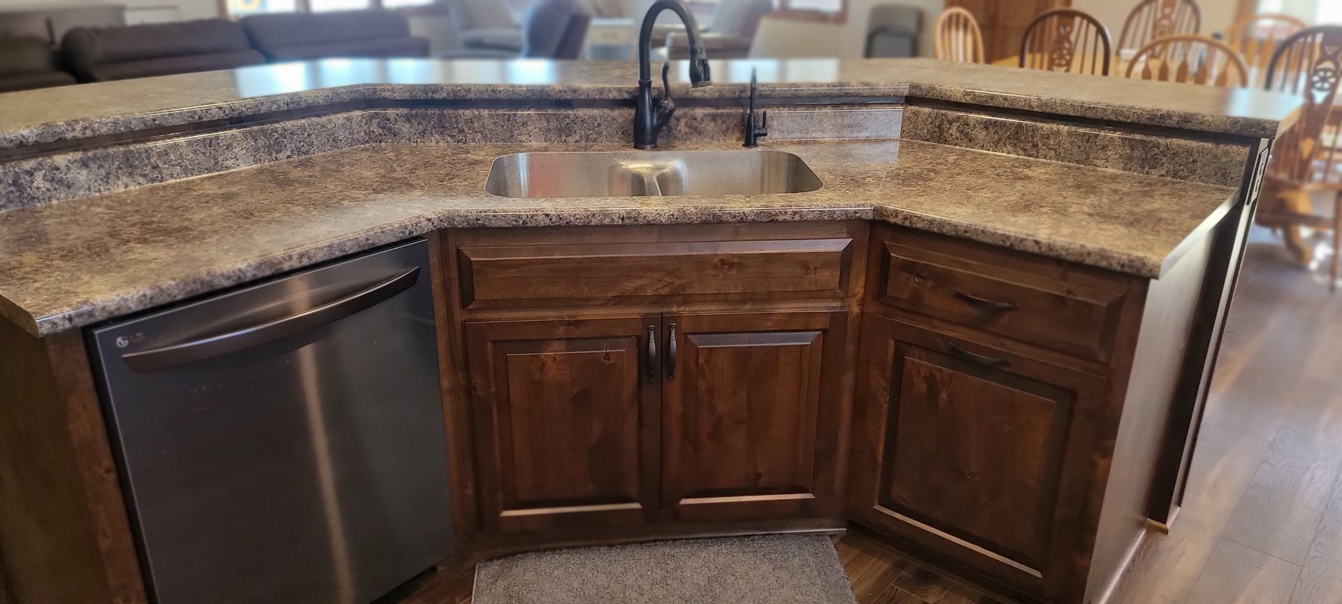 A kitchen with a sink, dishwasher, and granite counter tops.