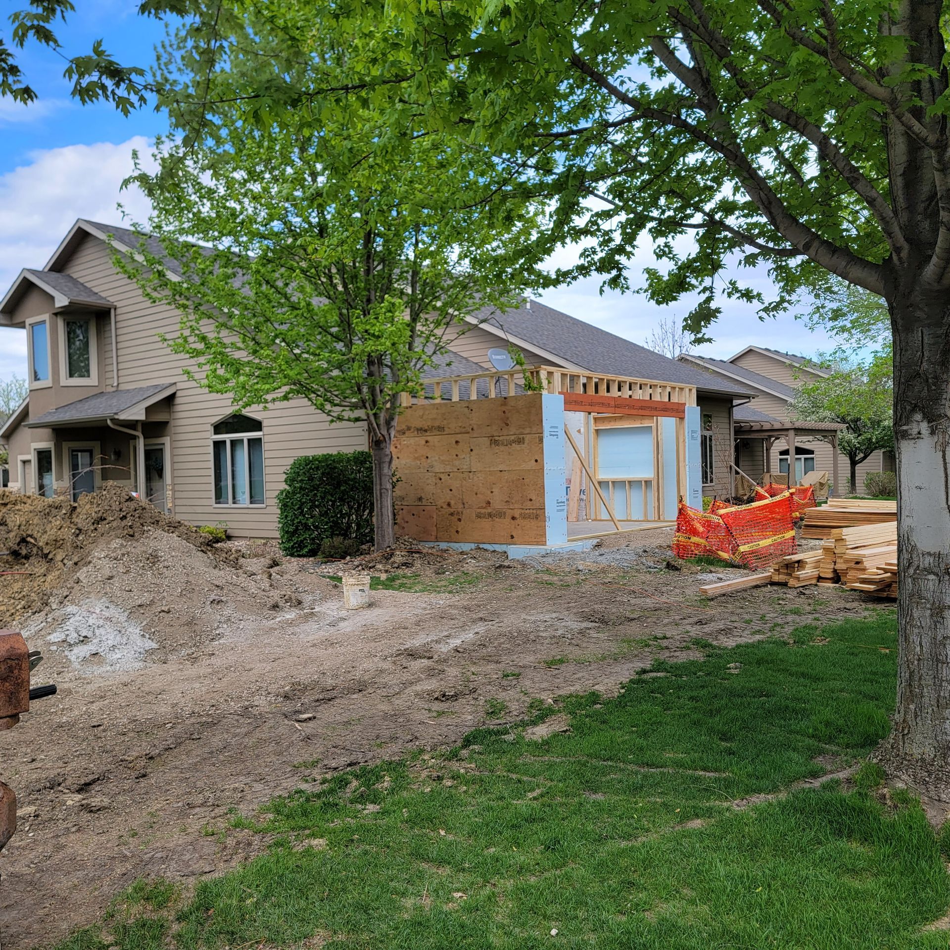 A house is being built in the middle of a yard.