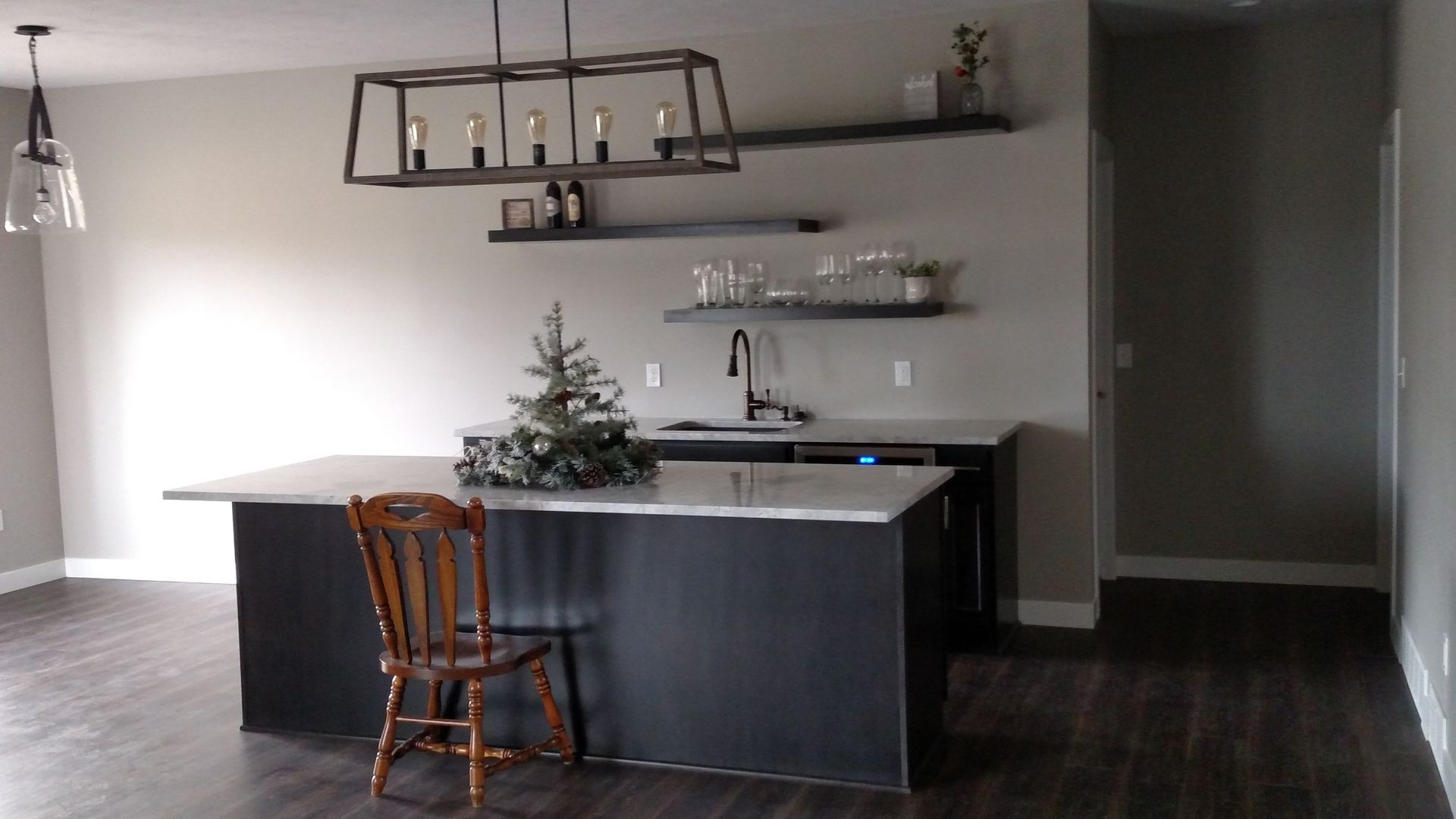 A kitchen with a large island and a chair