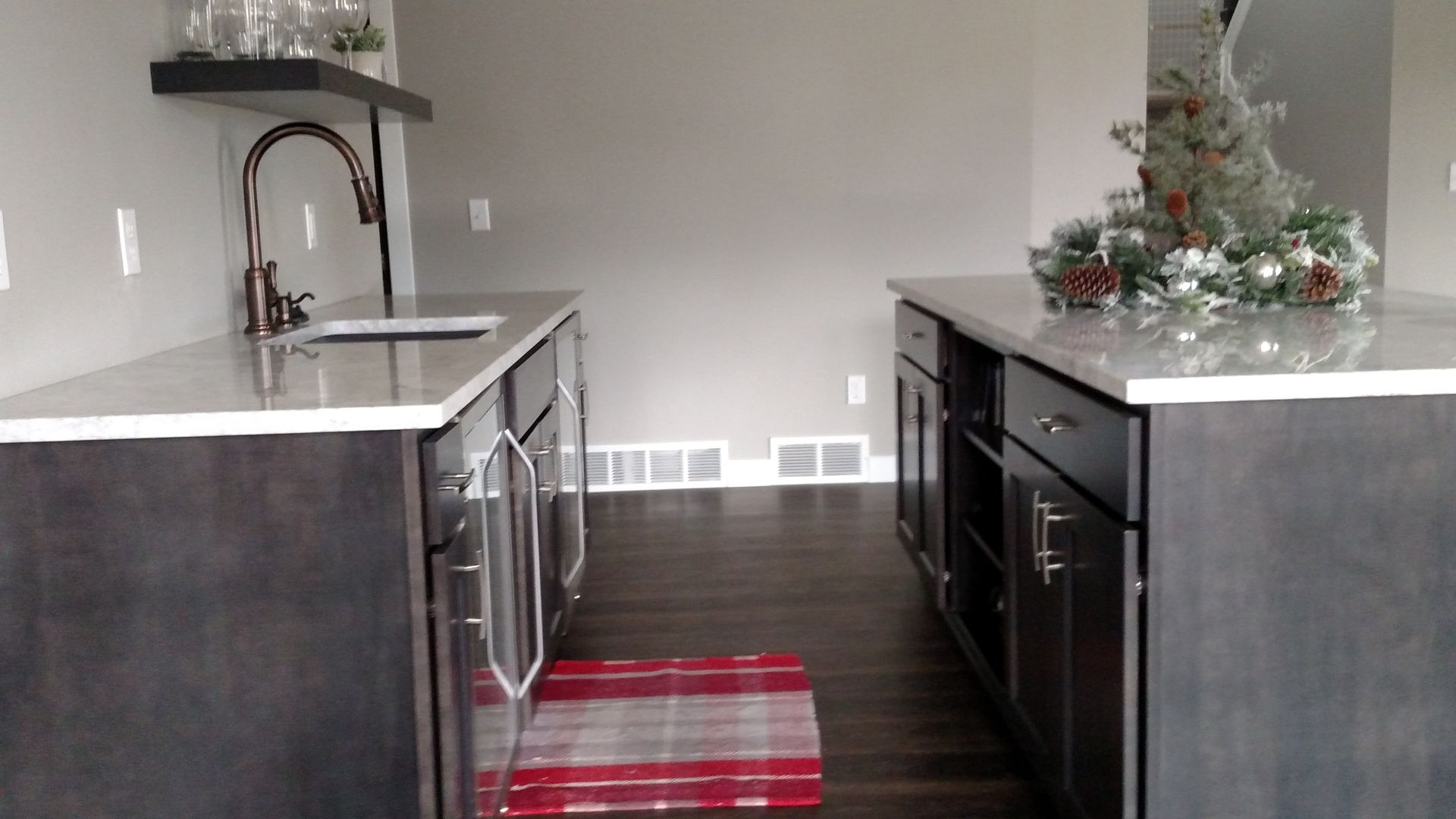 A kitchen with a sink and a rug on the floor