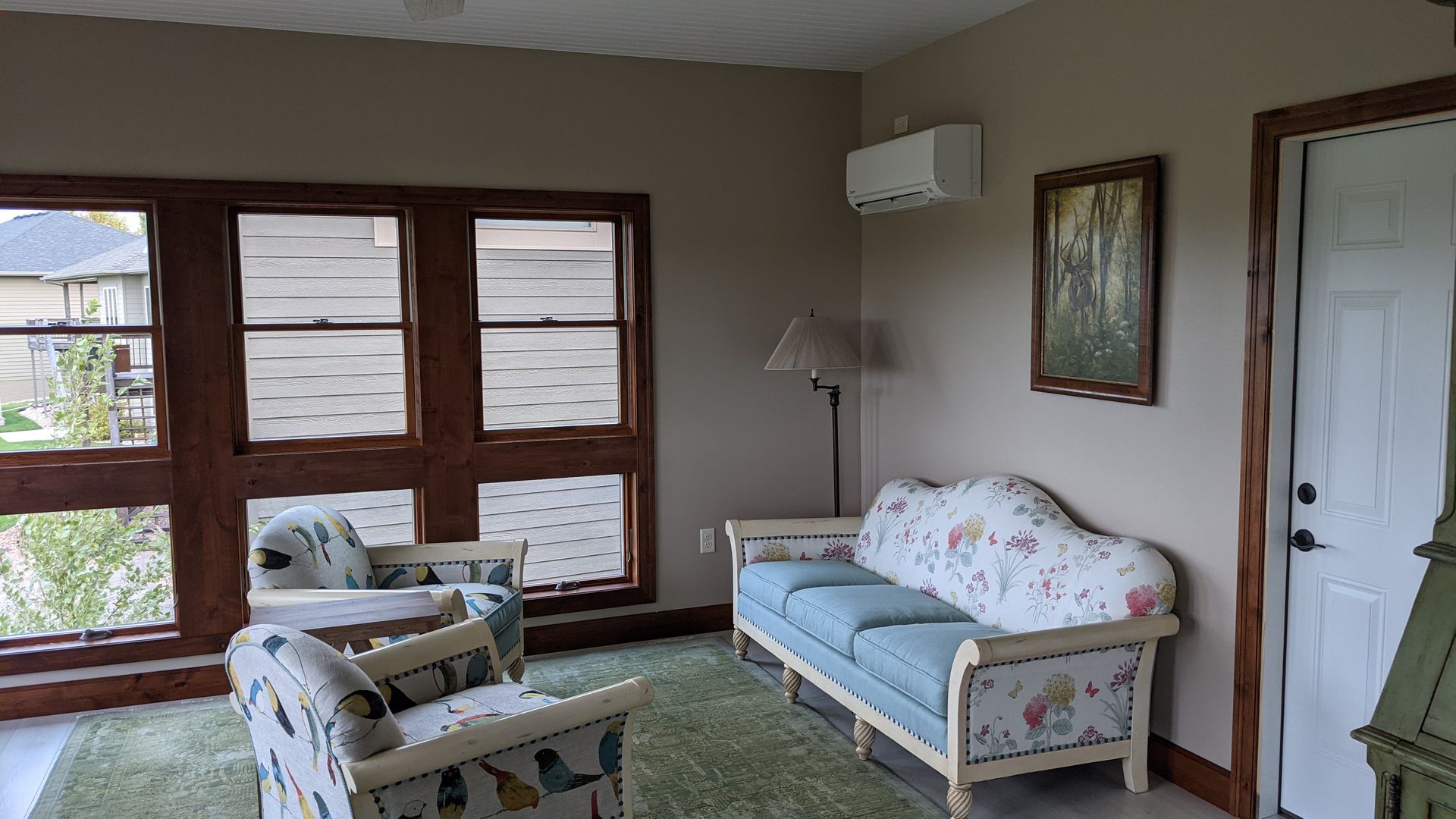 A living room with a couch and two chairs