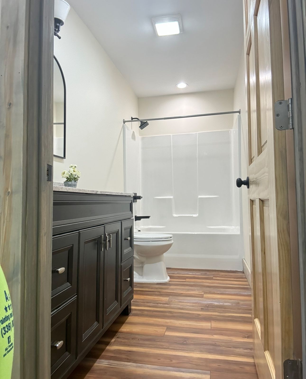 A bathroom with a toilet , sink , and shower.