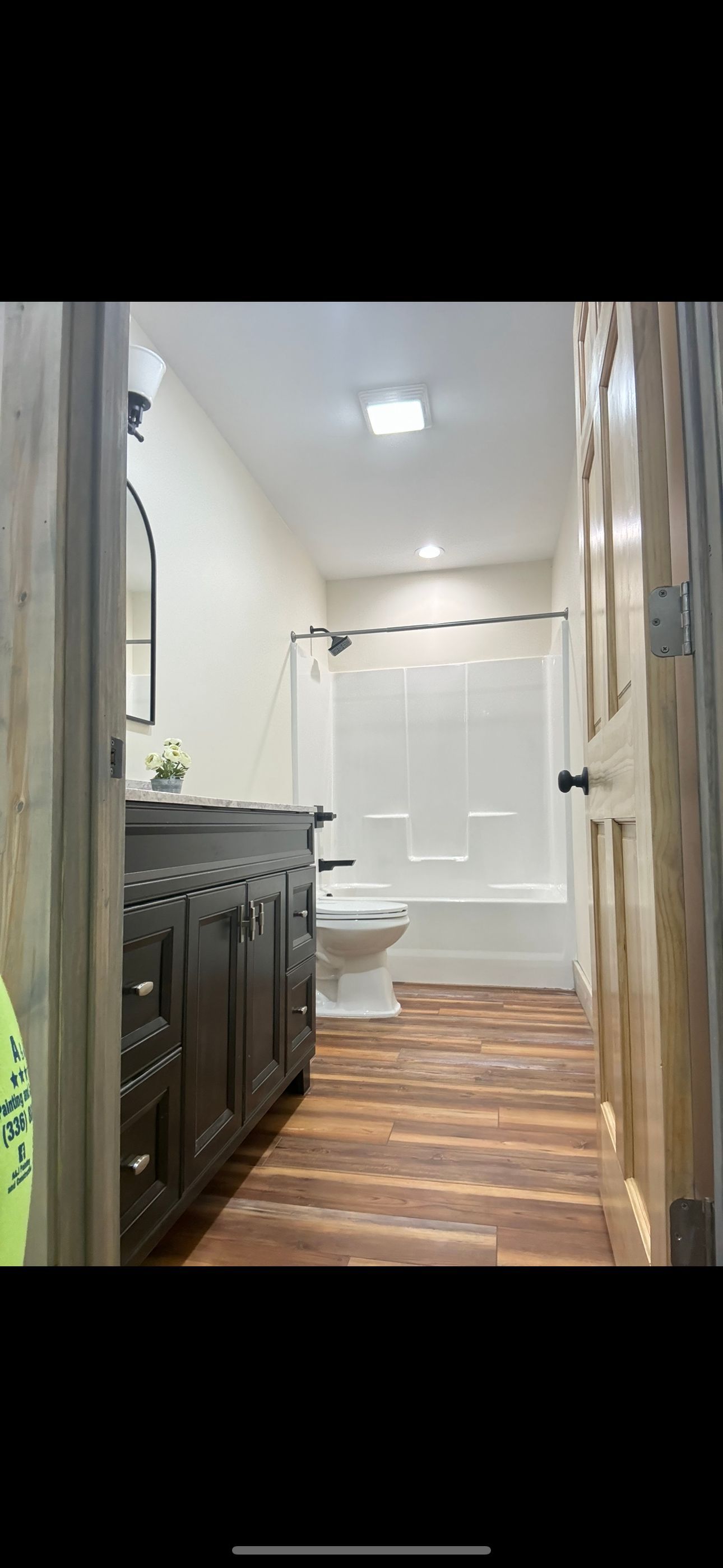 A bathroom with a toilet , sink , and shower.