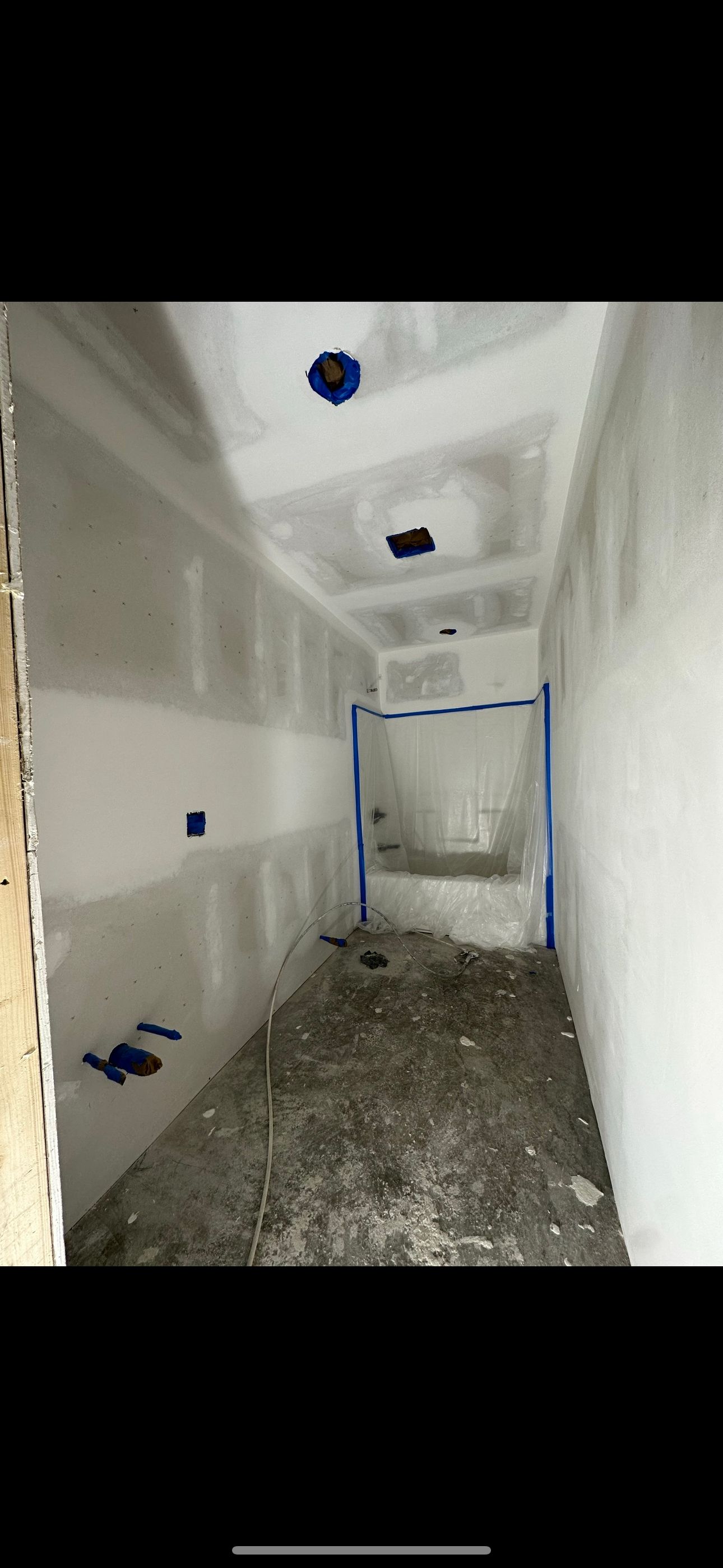 An empty room with a ceiling that is being built.