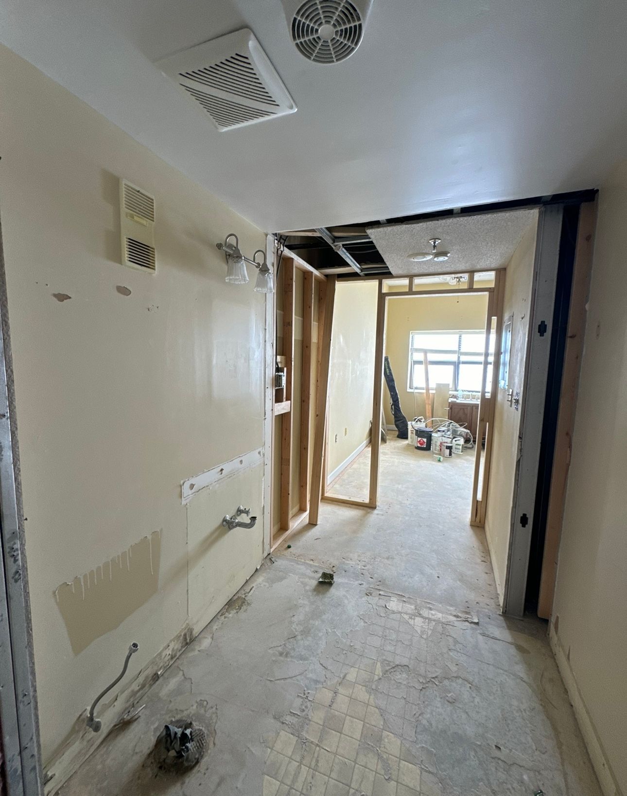A room that is being remodeled with a fan on the ceiling.