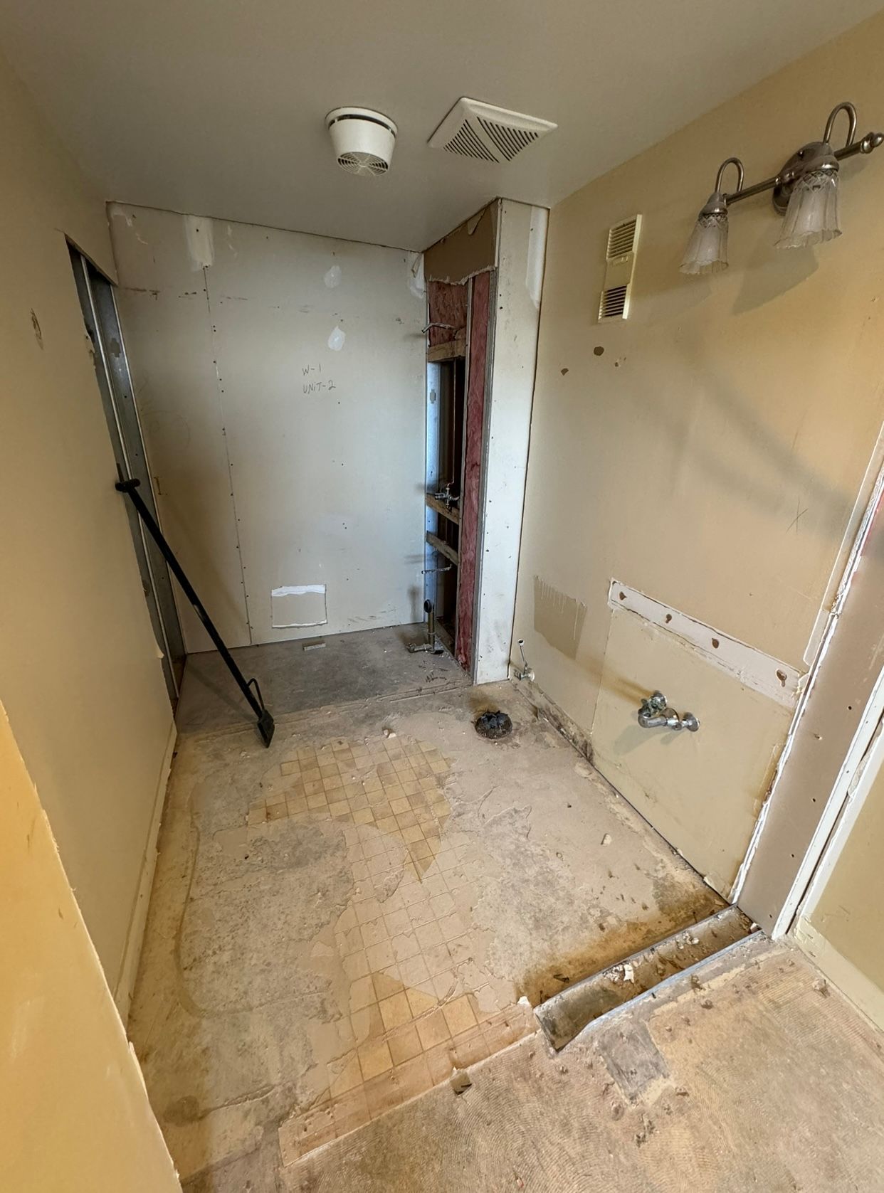 A bathroom is being remodeled and has a dirty floor.