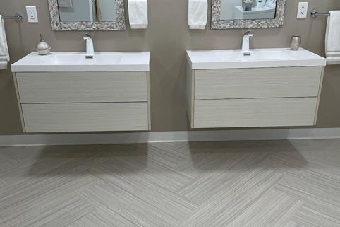 A bathroom with two sinks and two mirrors.