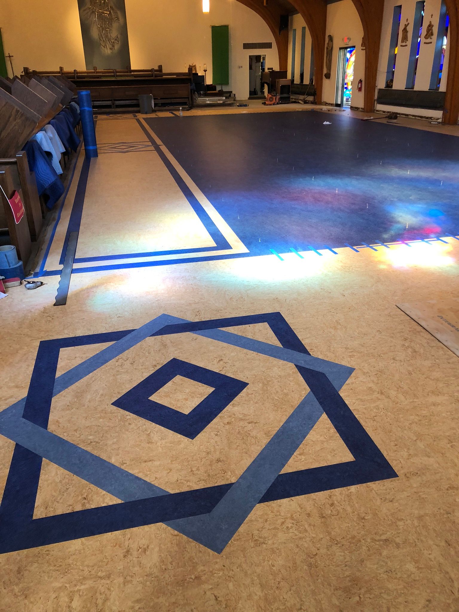 A large room with a blue and white geometric pattern on the floor