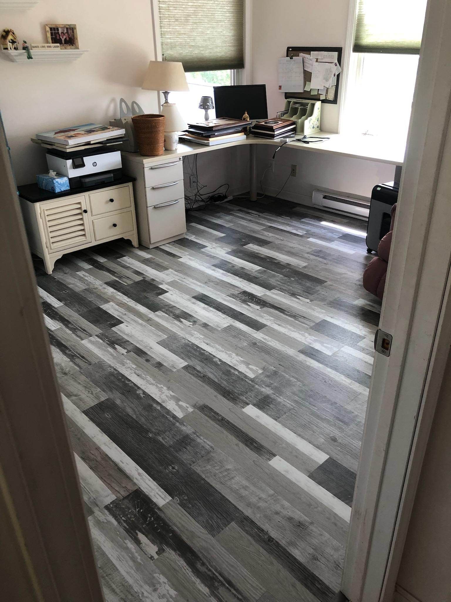 A room with a wooden floor and a desk.