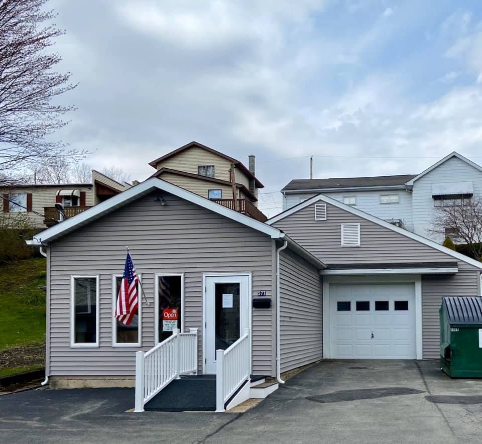 A small house with an american flag in front of it