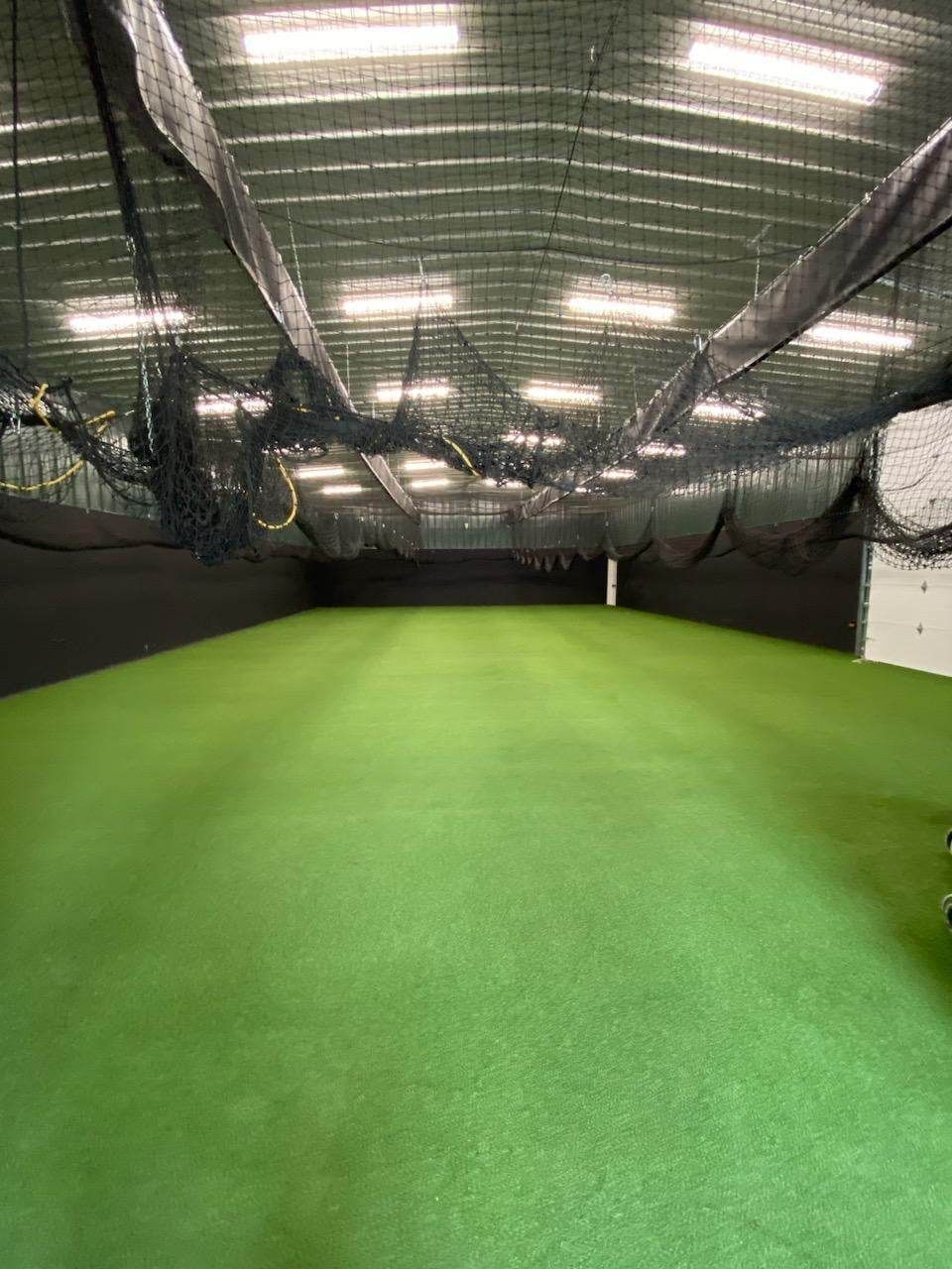 There is a large green field in the middle of a building.