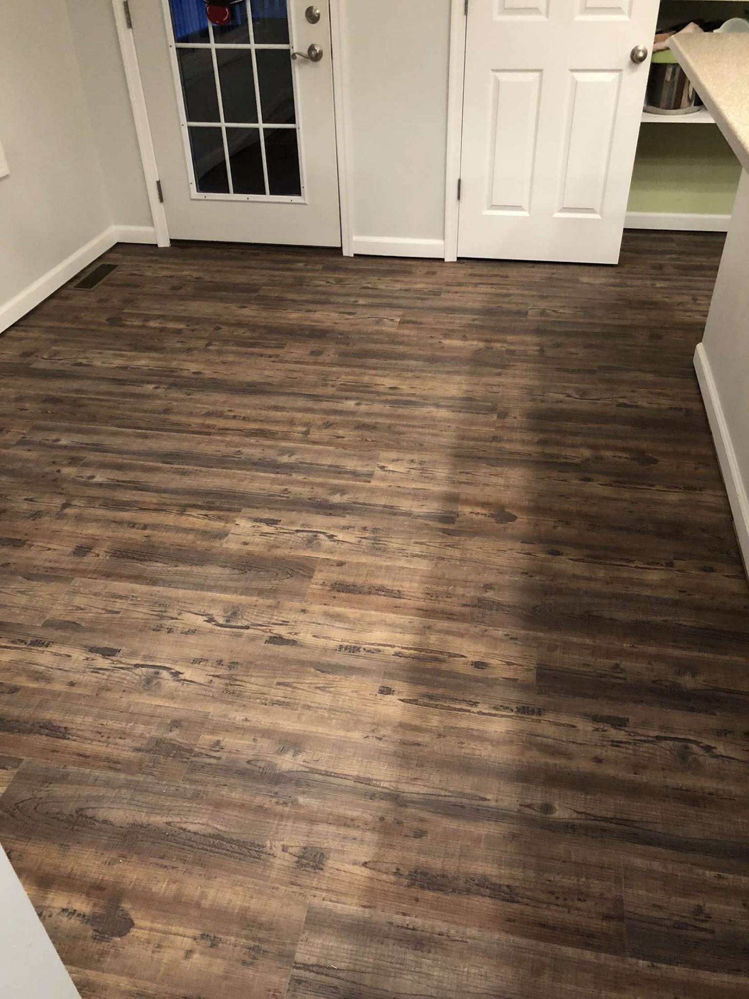 A room with a wooden floor and a french door.