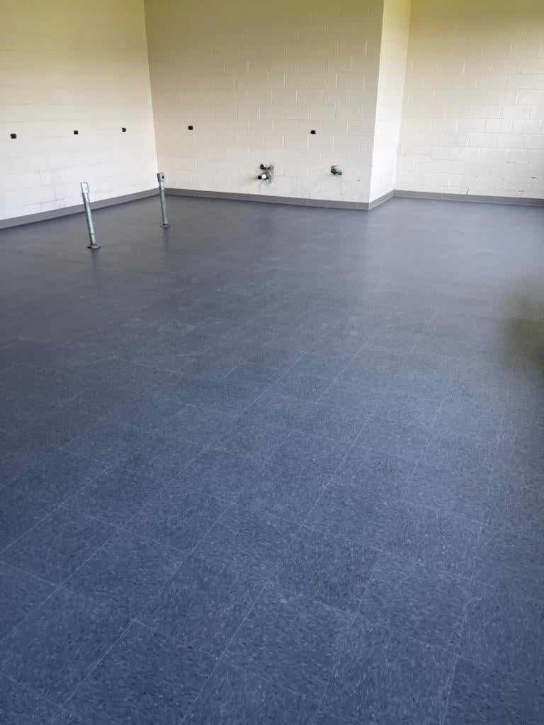 A room with a blue floor and white walls.