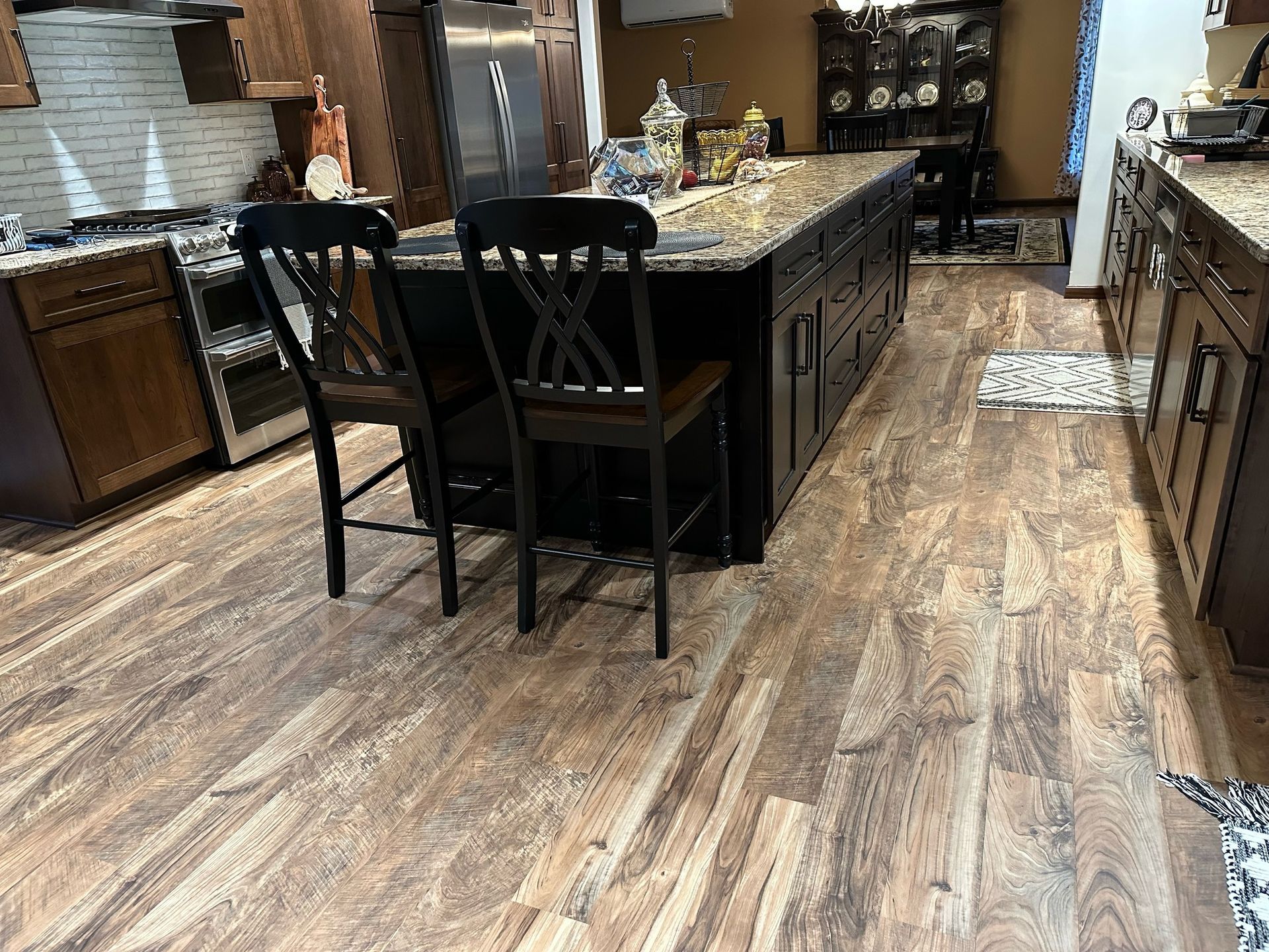 A kitchen with hardwood floors and a large island.