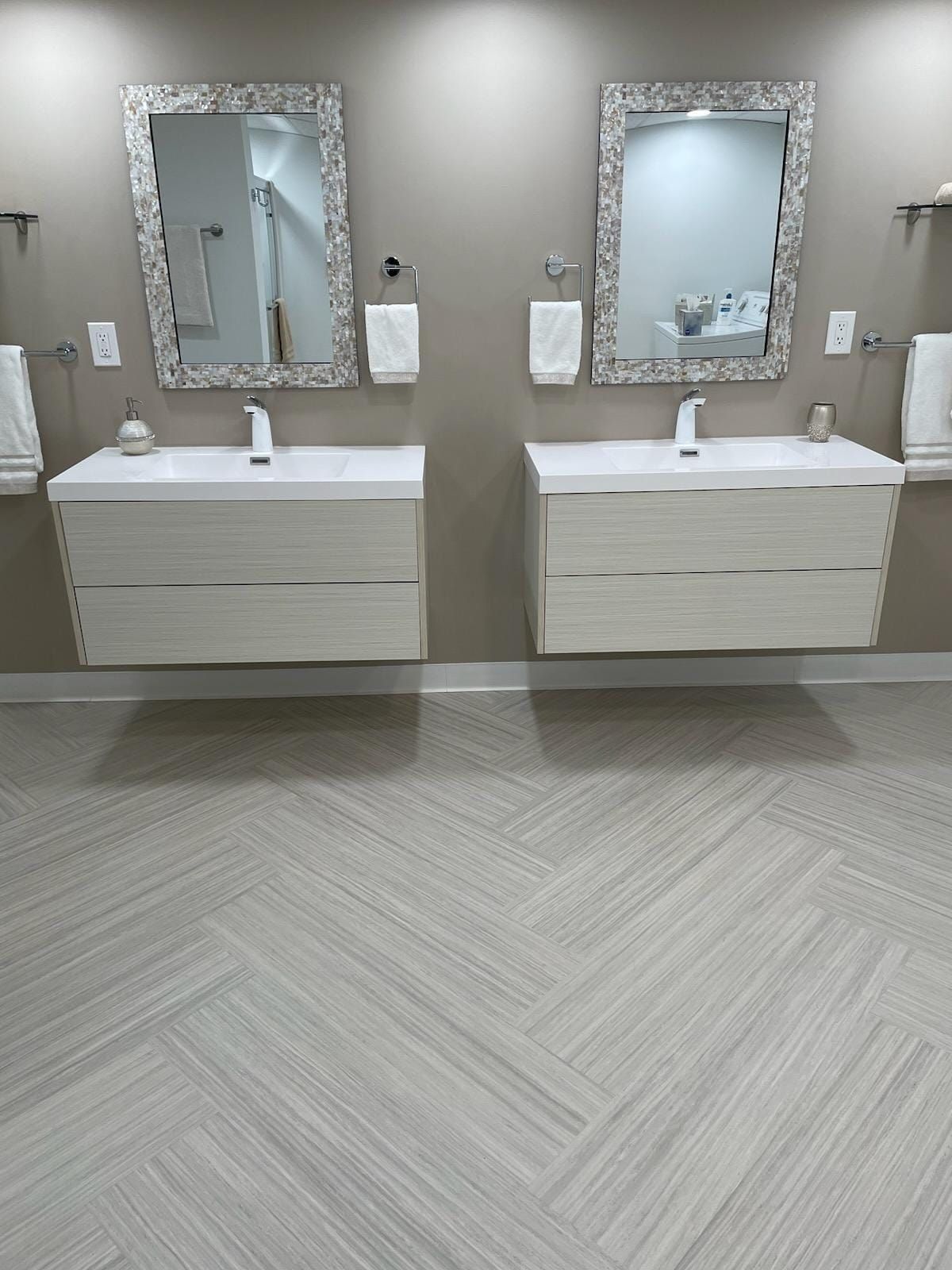 A bathroom with two sinks and two mirrors.