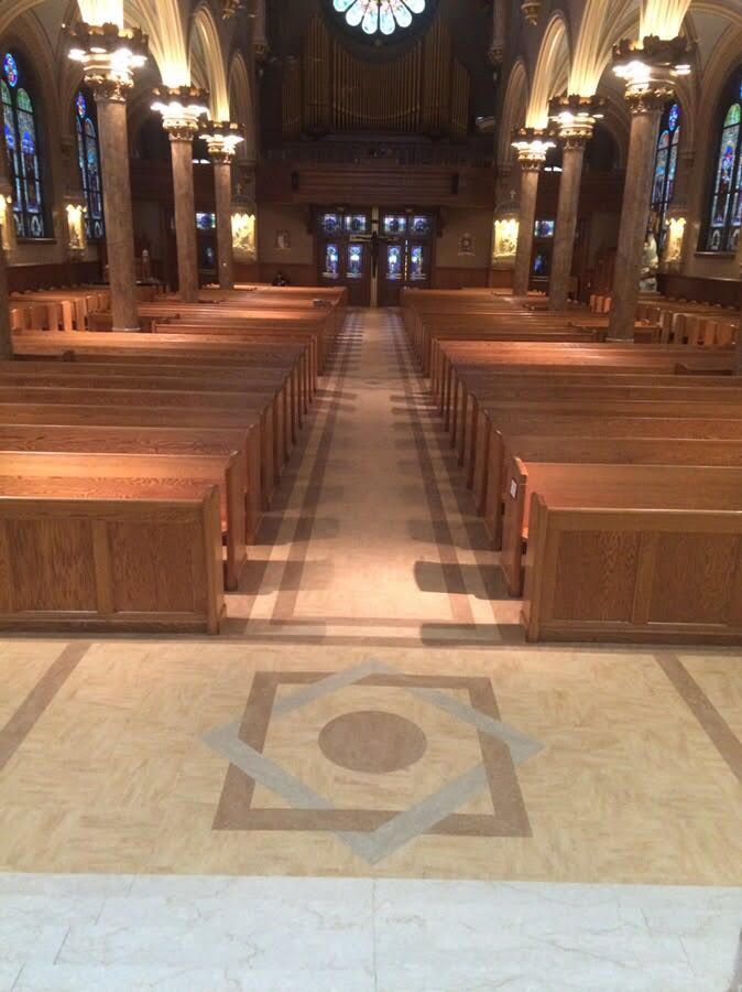 The inside of a church with rows of wooden benches