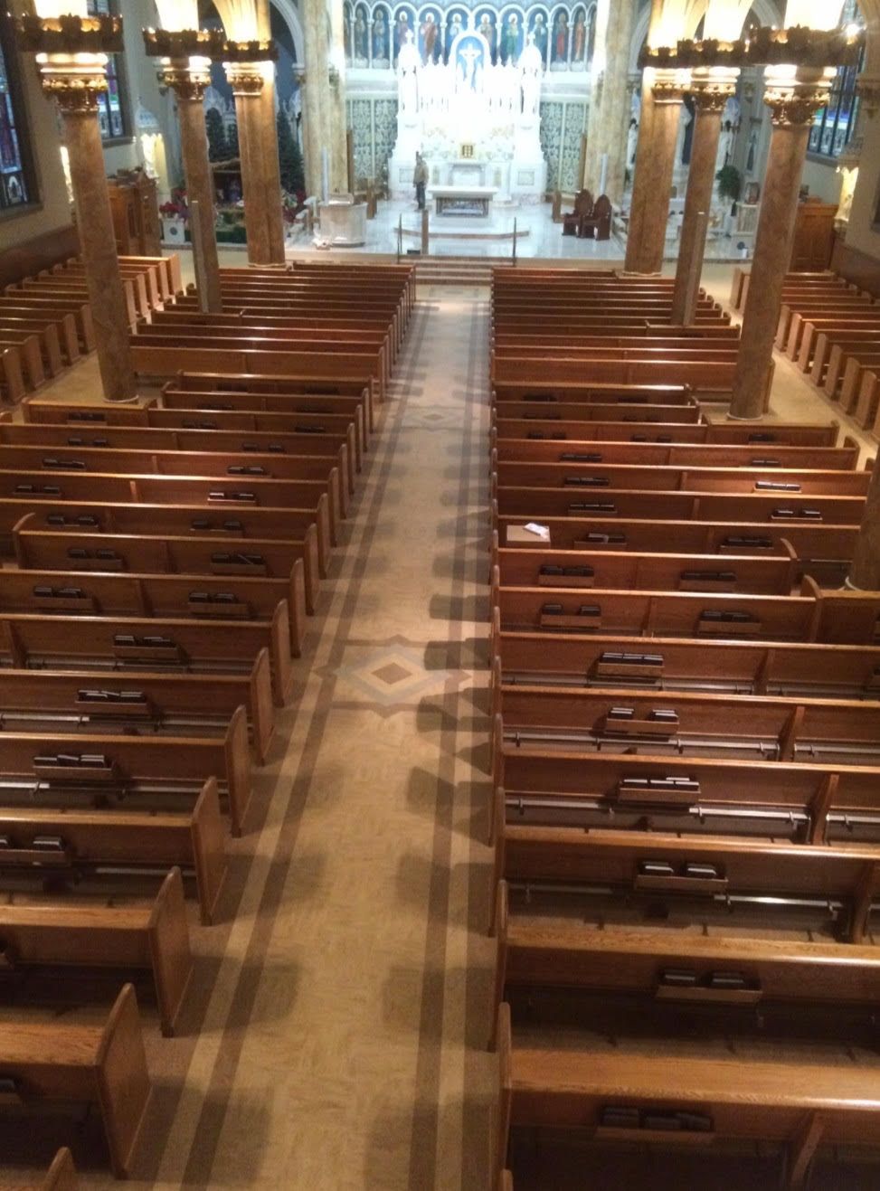 The inside of a church with rows of wooden benches