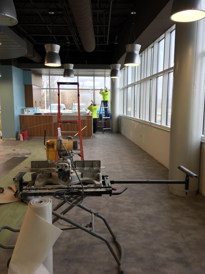 A room with a lot of windows and a saw on the floor