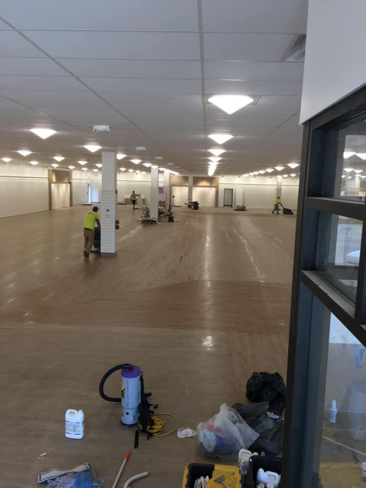 A large empty room with a vacuum cleaner on the floor