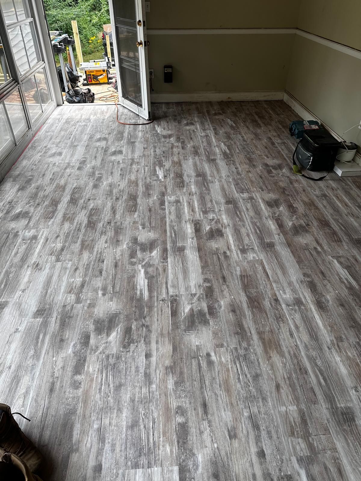 A room with a wooden floor and a sliding glass door.