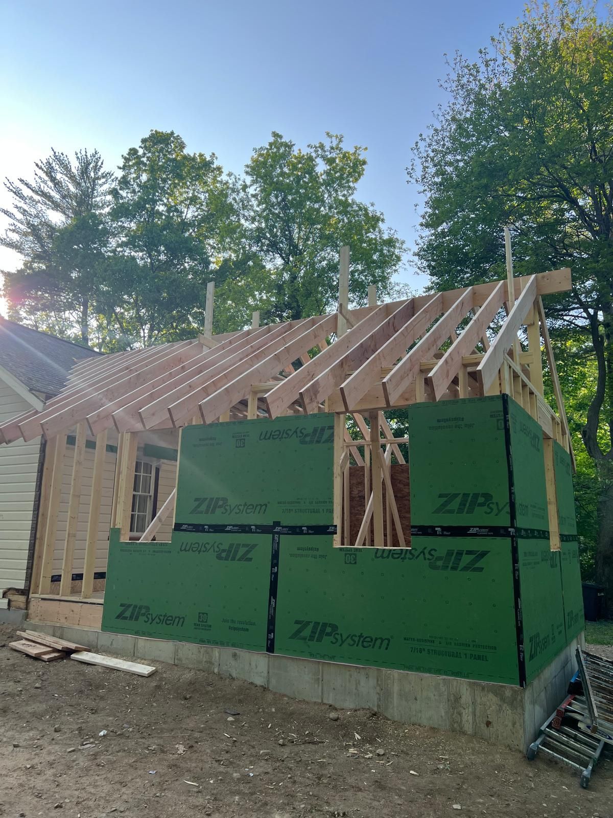 A house is being built with a roof that is being built.
