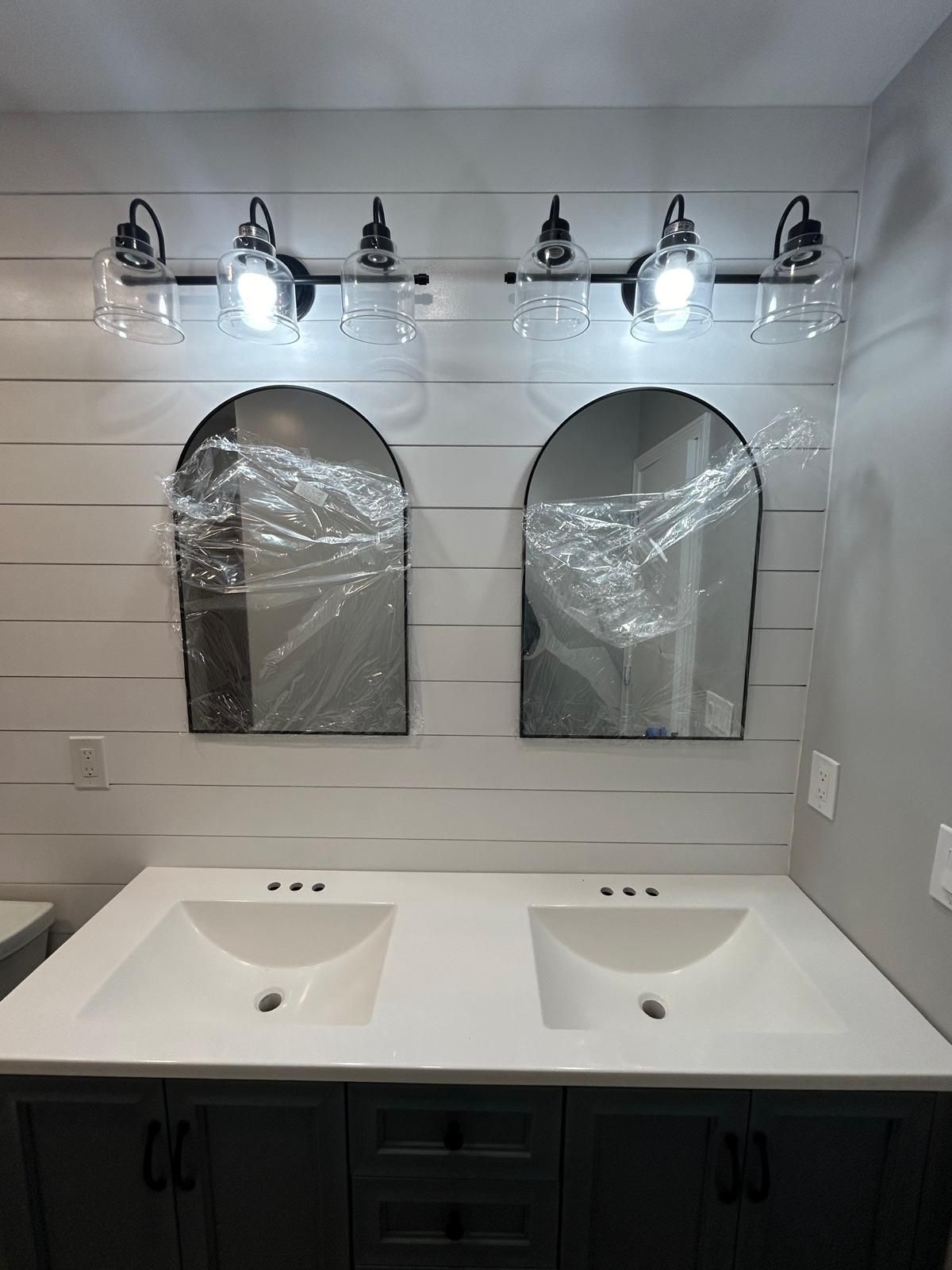 A bathroom with two sinks and two mirrors.
