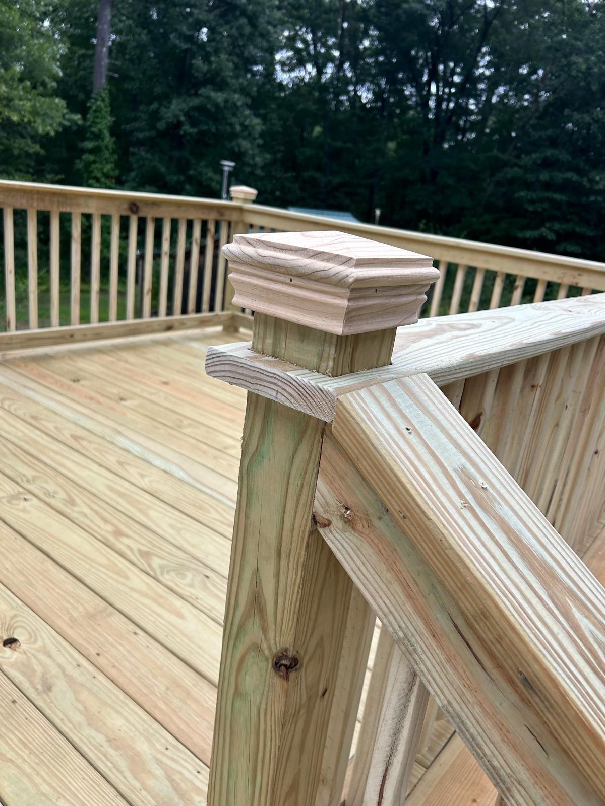 A close up of a wooden railing on a deck