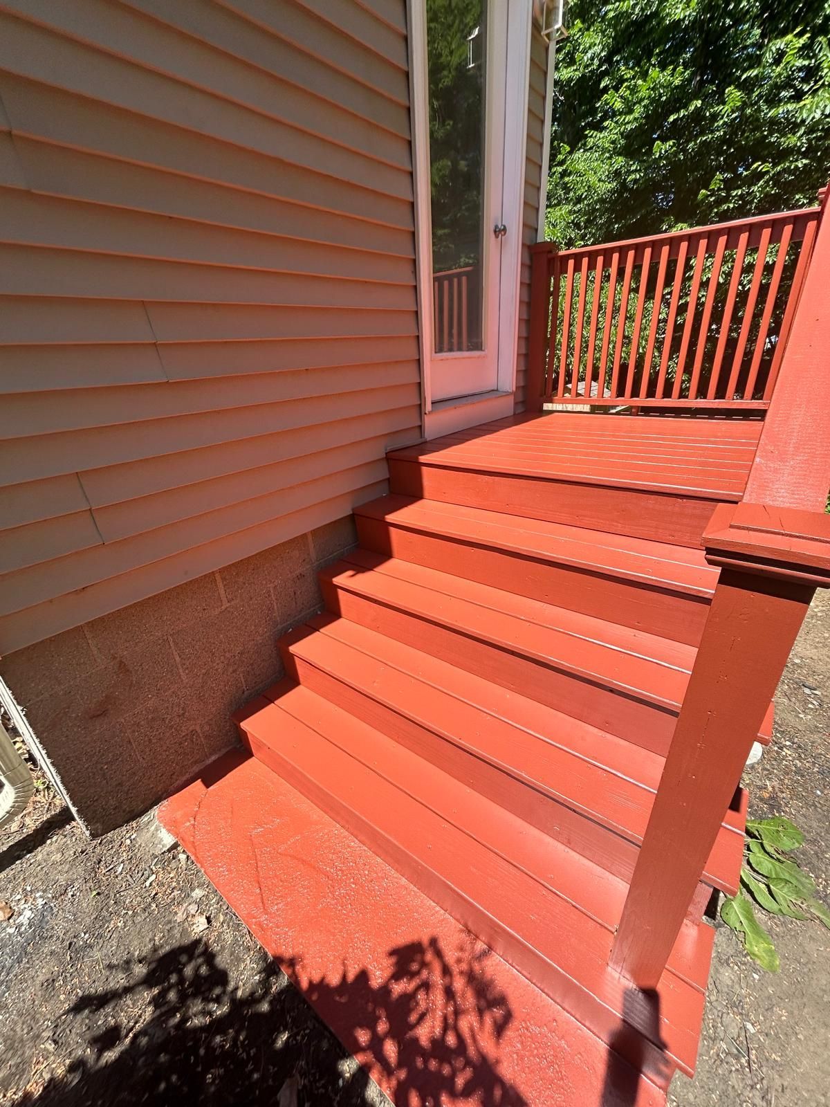 The stairs are painted red and the deck is painted red.