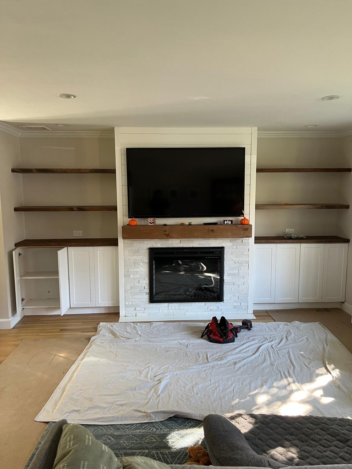 A living room with a fireplace and a flat screen tv.