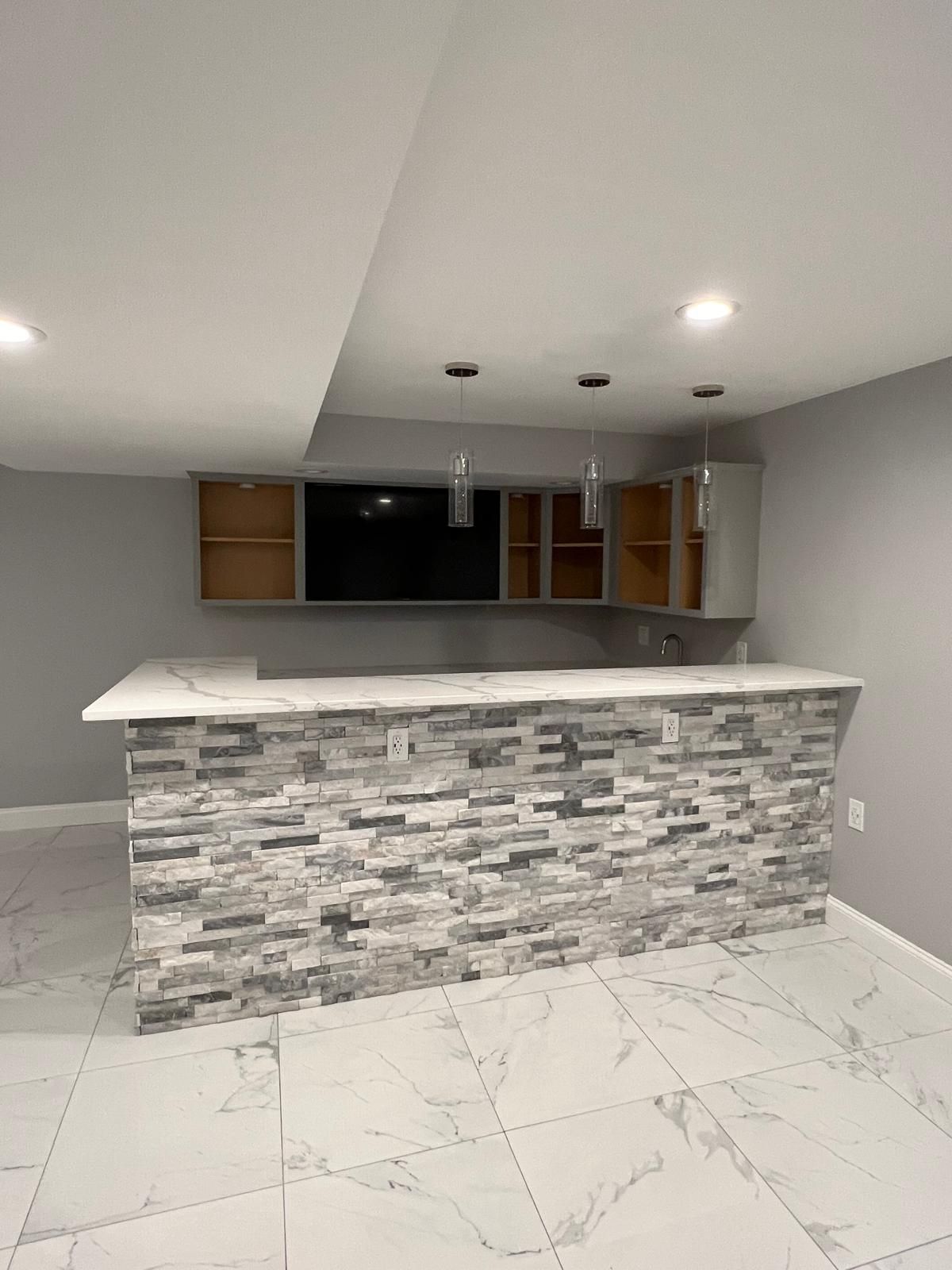 There is a large stone bar in the middle of the room.