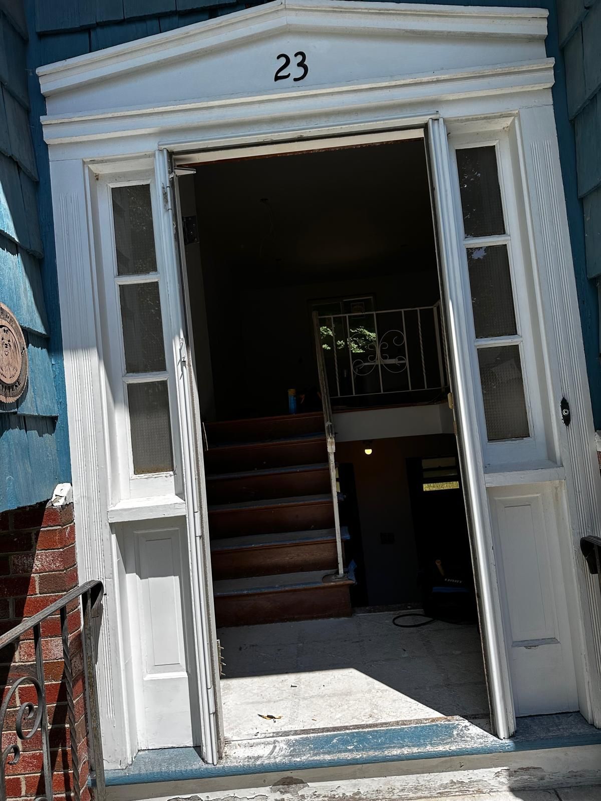 The front door of a building with the number 23 on it