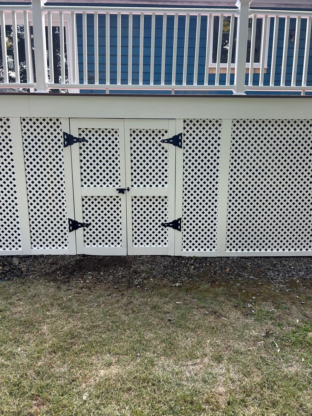 A white fence with a blue railing behind it