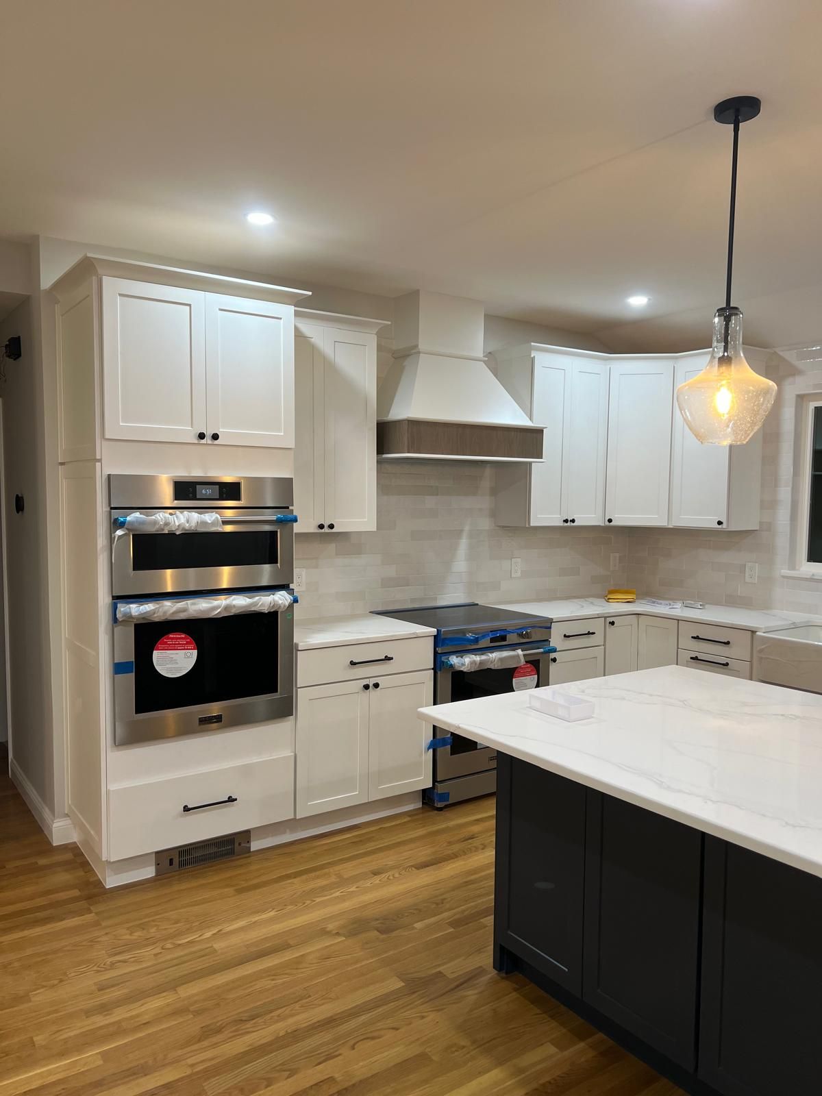 A kitchen with white cabinets and stainless steel appliances.