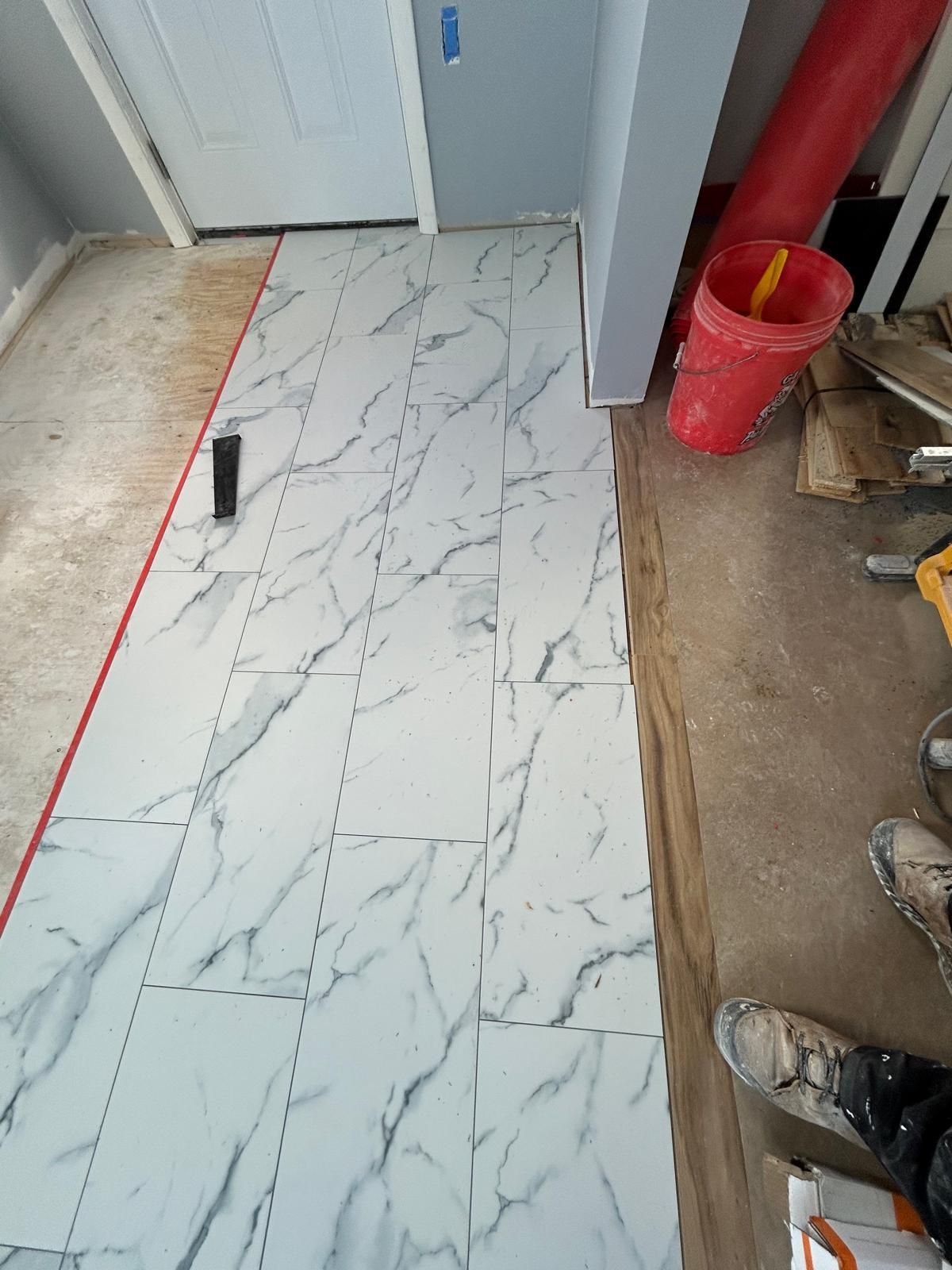 A marble floor is being installed in a room.