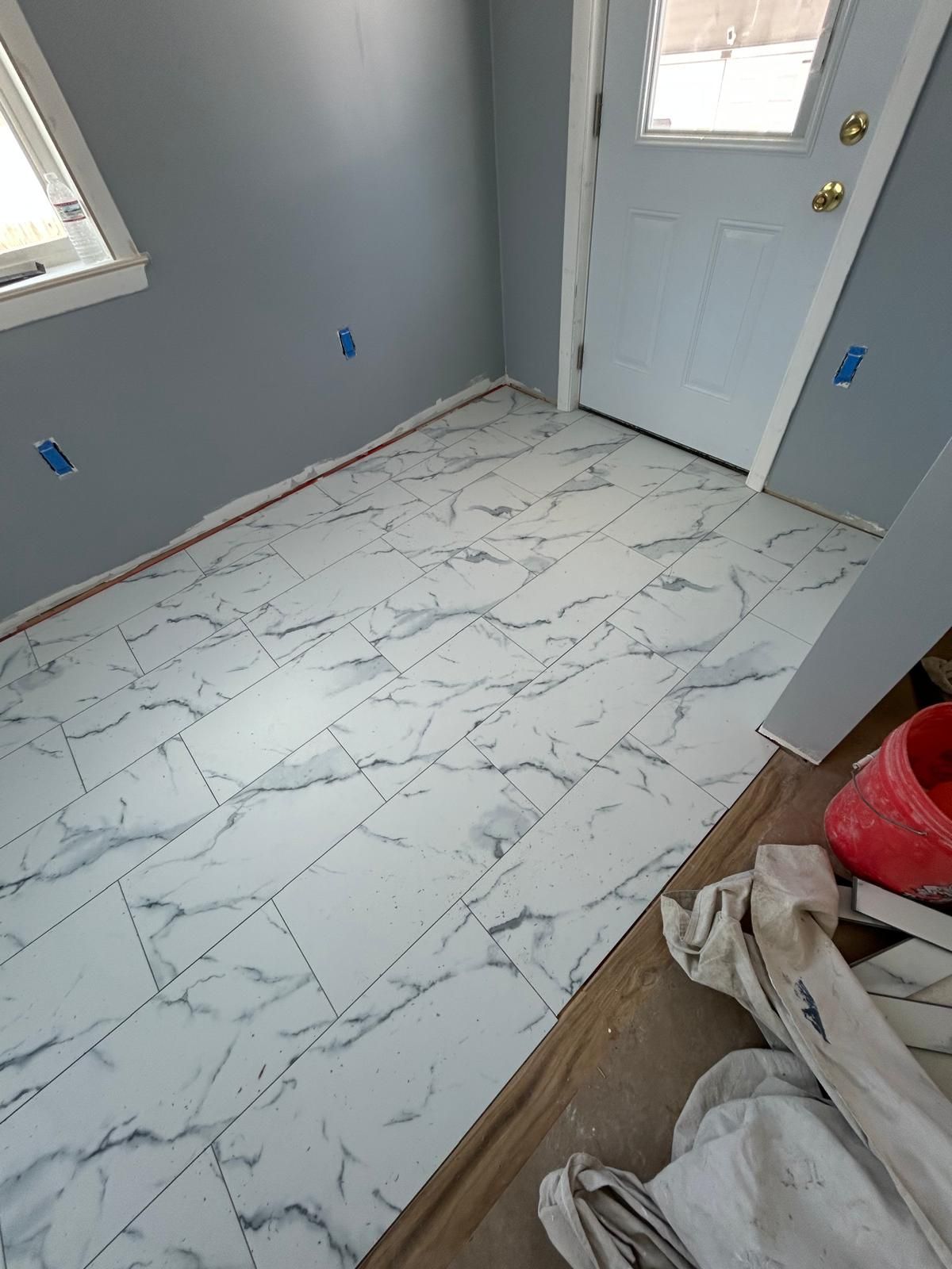 A room with a marble floor and a door.