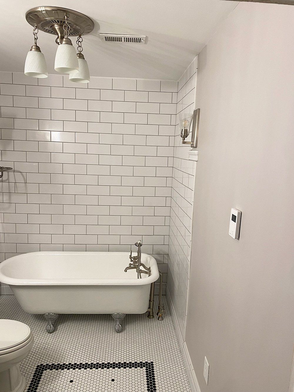 Newly remodeled white tile bathroom