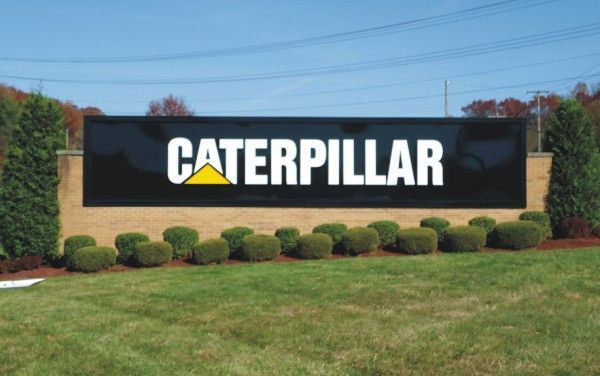 Caterpillar signage with bushes under