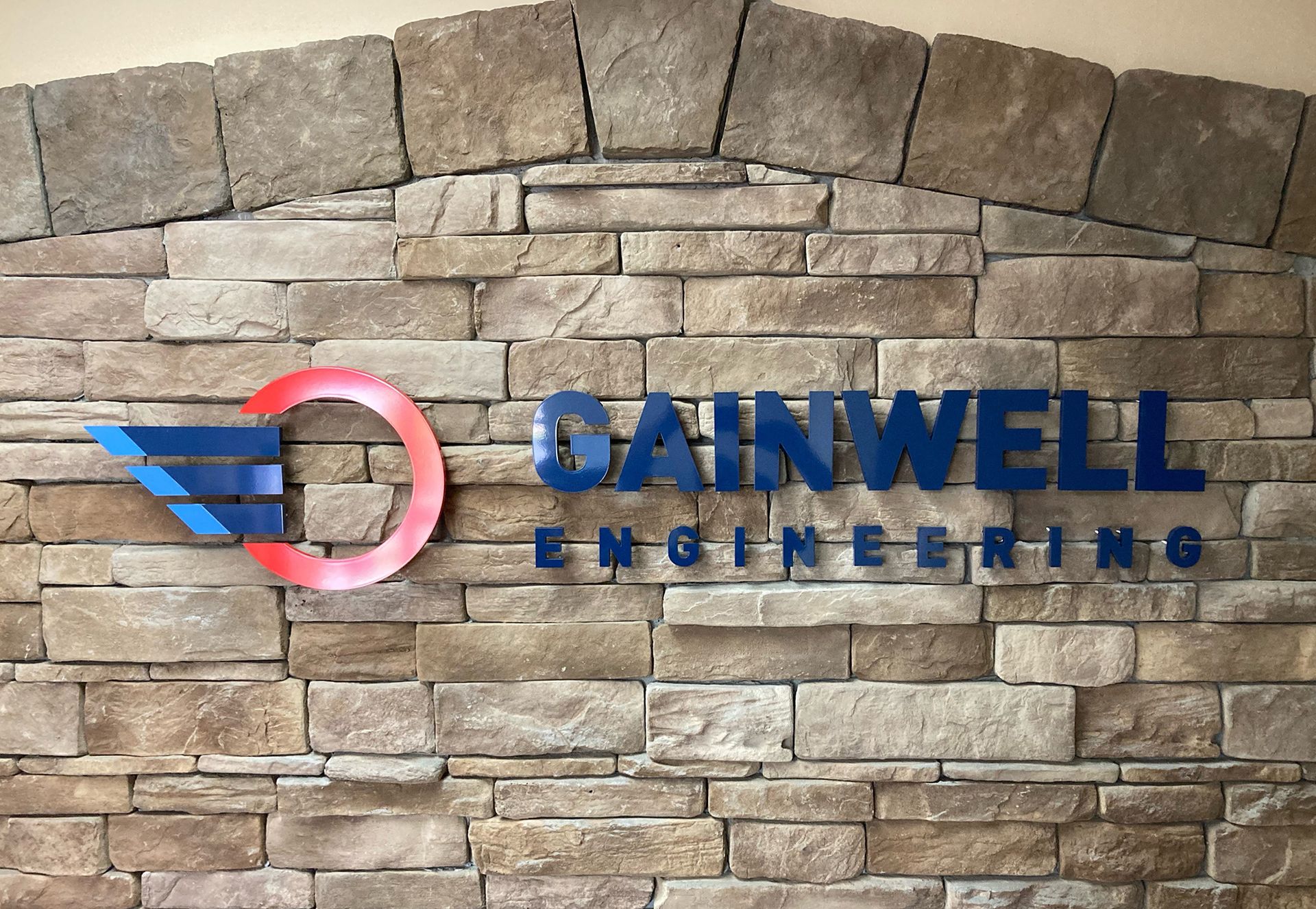 A brick wall with a sign that says Gainwell Engineering
