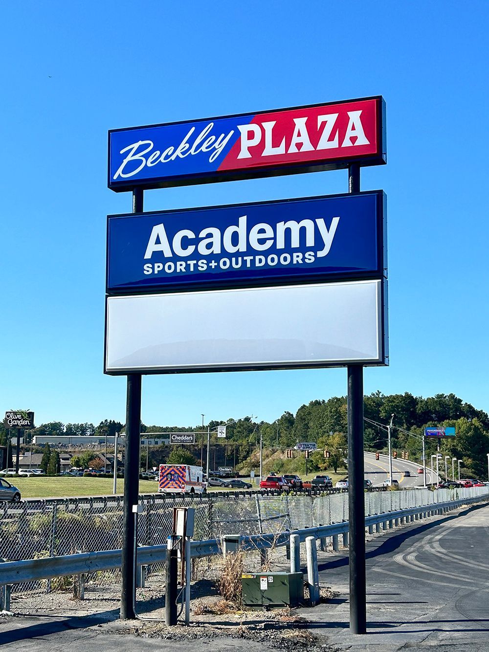 A large billboard sign for Academy Sports and Outdoors