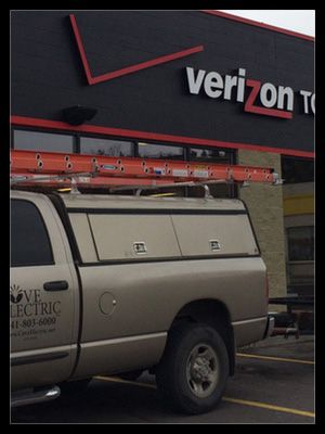 A truck is parked in front of a verizon store