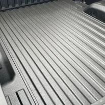 Black ribbed truck bed liner with ridged floor and sidewalls