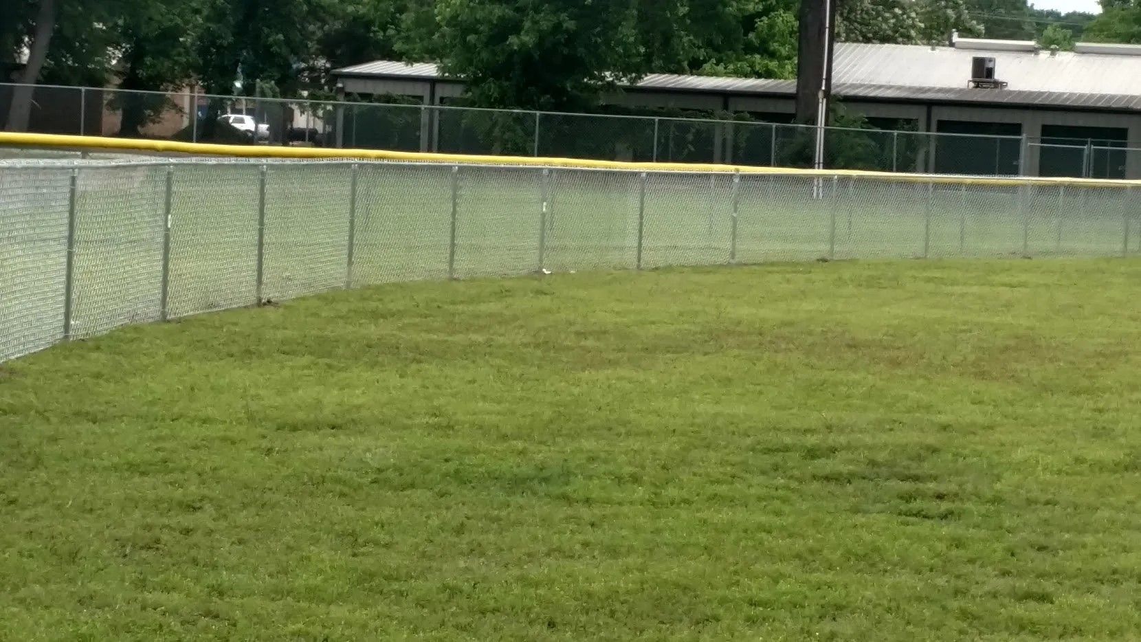 A baseball field with a chain link fence surrounding it.