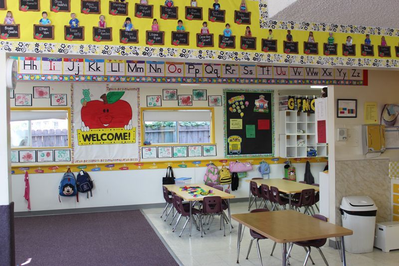 A classroom with a welcome sign on the wall